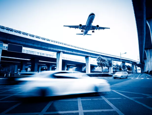 blurred-street-scene-city-with-plane-flying